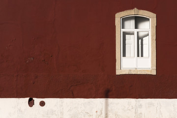 Window on bordeaux wall