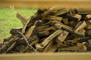 Pile of timber firewood nearby the road