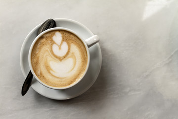 Tasty classic coffee cappuccino in white porcelain cup. View from above with Copy Space.