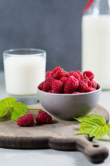 Fresh cow milk and ripe organic red raspberry