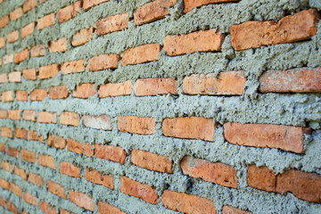 Aged red bricks wall close up background.