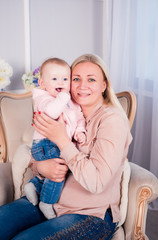 A little baby girl is photographed in a beautiful outfit for 6 months