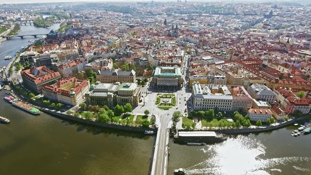 Aerial Bird Eye View of Prague Center Old Town Cityscape in Czech Republic feat. Vltava River and Boats on a Sunny Day in 4K Ultra HD