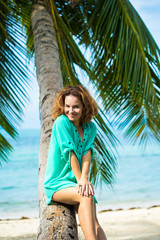 the emotional portrait of Fashion a stylish portrait of the nice young hipstersky woman rezhy, going crazy, soft flowers. in the tropical country of Thailand, against the background of palm trees