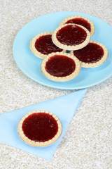 top view strawberry tart on blue napkin