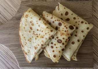 Dessert of pancakes on plate on table with eggs