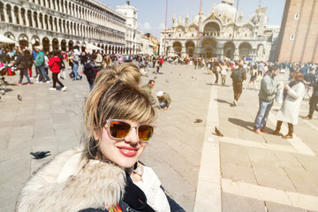 Fototapeta premium Beautiful Young Girl Woman Student Making Selfie Behind San Marco Venetian Background. Venice, Italy. Travel Concept.