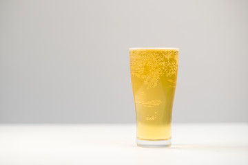 beer in pint glass on white background