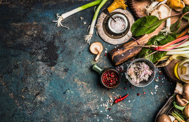 Fresh seasoning and vegetarian organic cooking ingredients for tasty cooking on dark rustic...