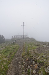 Mist covers the cross in the early morning time