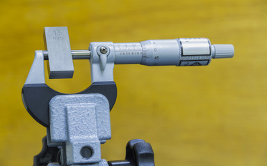 Calibration outside micro meter with gauge block in  laboratory.
