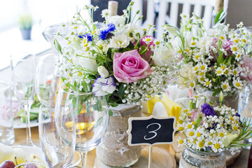 Wedding festive interior, table decorations, flowers, table setting, wine glass, pastel summer tones