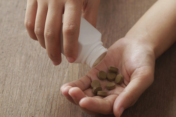 herb medicine in hand  on wood table