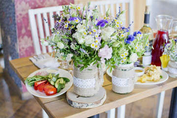 Obraz na płótnie Canvas Wedding festive interior, table decorations, flowers, table setting, wine glass, pastel summer tones
