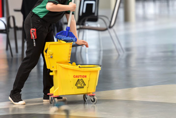 Yellow mop bucket and set of cleaning equipment