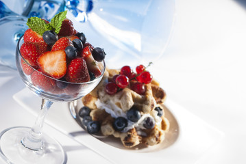 waffles with cream & Berries on white plate 