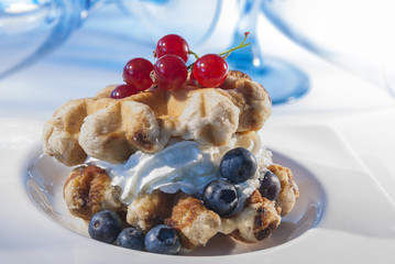 waffles with cream & Berries on white plate 