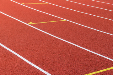 Fototapeta premium Red running track and white lanes on sport stadium