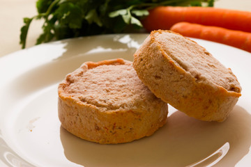 Frozen carrot patties on a white plate. The concept of a healthy diet.