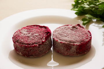 Frozen beet cutlets on a white plate. The concept of a healthy diet. Vegetarian dish.