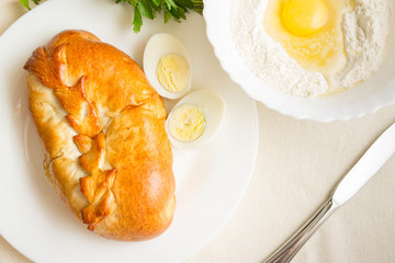 Meat pie with egg and vegetables. Nutritious and tasty dish.
