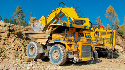 Big mining truck and excavator