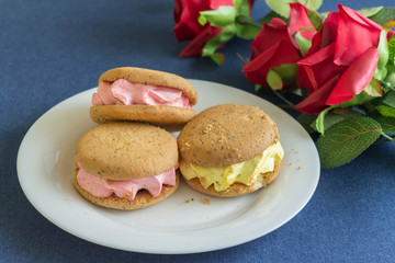 Cakes and roses on denim. Romantic composition. Holiday card.