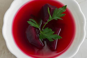 Beet soup in a white bowl. Delicious dietary dish.