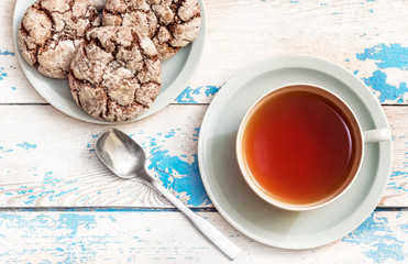 Cup of tea with cookies and teaspoon on the table. Top view.