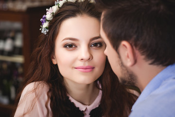 Young enamored couple sitting at a table in a cafe 