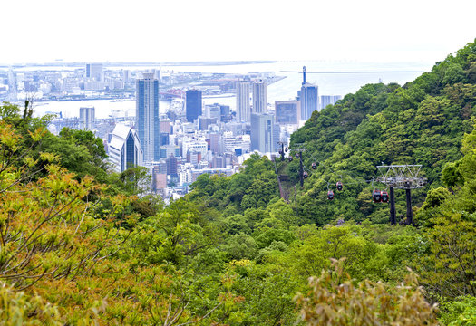 Kobe cityscape and skyline, Kobe Port Island and Kobe Airport in Osaka Bay seen from Nunobiki Herb Garden on Mount Rokko in Kobe, Japan