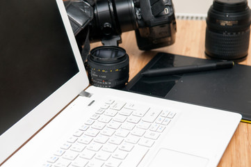 Professional photography editing equipment with camera and laptop