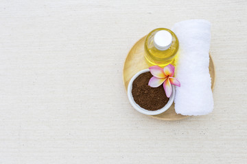 Coffee body scrub and white towel on wooden tray with space on canvas background