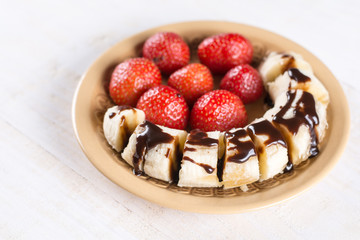 Fresh strawberries with sliced banana and topped chocolate cream