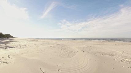 Aerial view of Baltic sea shore, waves and sandy beach.