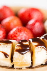 Fresh strawberries with sliced banana and topped chocolate cream