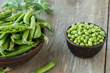 young peas on a wooden table