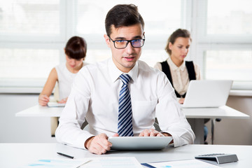 Young businessman using computer in the office