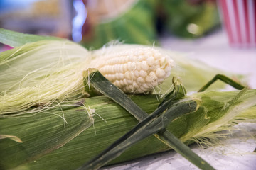a half peeled ear of corn