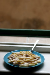 Simple pasta recipe with tuna, cream and onion. Selective focus. 
