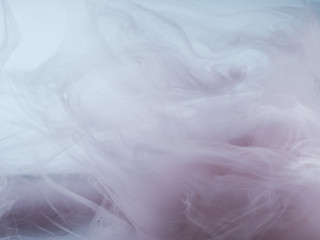 Abstract colored background. Colored smoke, ink in water, the patterns of the universe. Abstract movement, frozen multicolor flow of paint. Horizontal photo with soft focus, blurred backdrop.