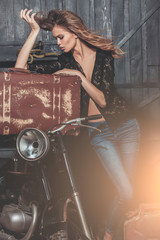 Plakat travelling and active lifestyle, girl biker with suitcase at motorcycle