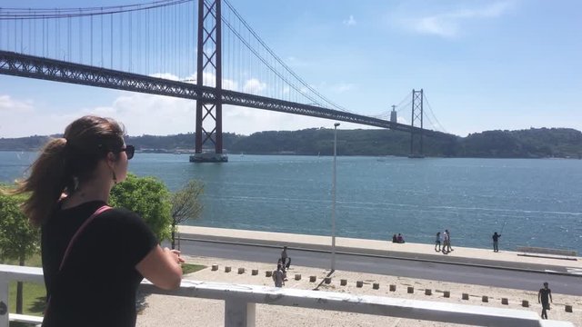 Young Woman Visits Lisbon Landmarks. Lisbon is the capital and the largest city of Portugal