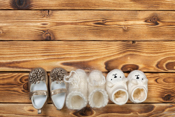 baby's bootee on wooden background