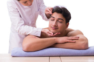 Handsome man in spa massage concept