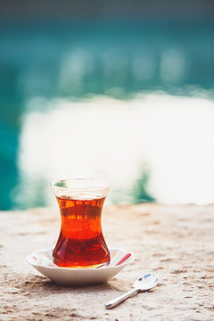 Hot turkish tea outdoors near water. Turkish tea and traditional turkish culture concept