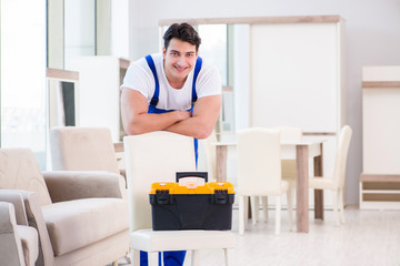 Furniture repairman working in store