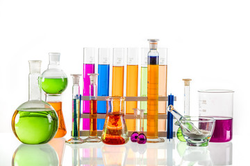 Laboratory glass set filled with colorful substances.