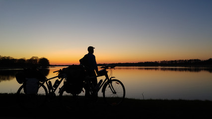 Mazury, Poland. Sunset lake landscape with the bicycles - obrazy, fototapety, plakaty