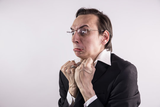 Angry and frustraded business man grimacing at his workplace